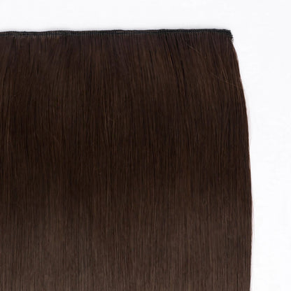 Close-up view of Stranded Hair Group straight clip-in extension in shade #4 Chocolate Dahlia