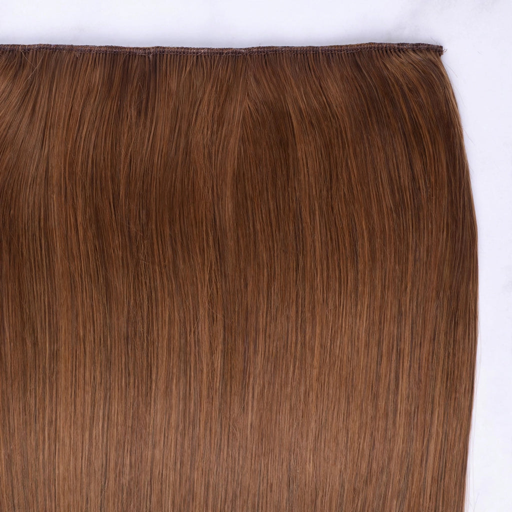 Close-up view of Stranded Hair Group clip-in hair extension in Caramel Cosmos shade