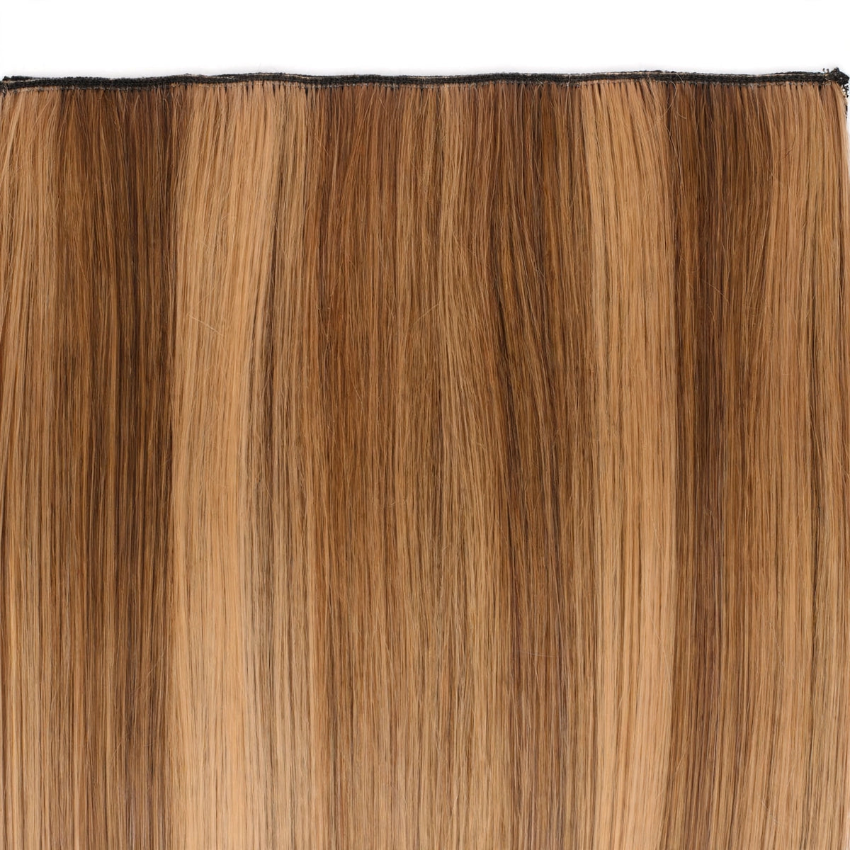 Close-up view of Stranded Hair Group clip-in extension in warm brown and golden Honey Blush colour