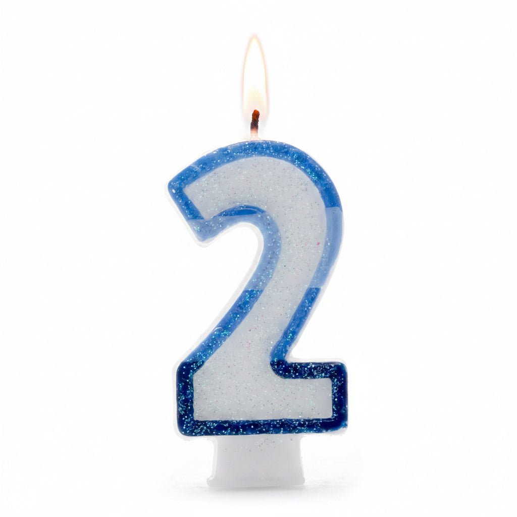 A glittery number 2 birthday candle with a blue glitter border and white glitter-filled center, shown on a white background.