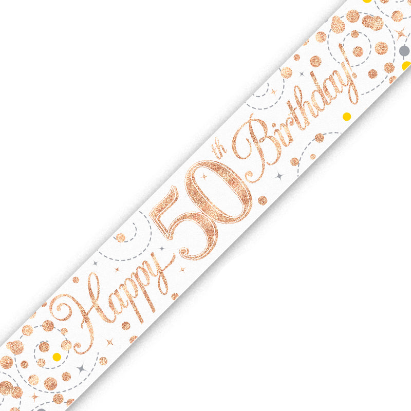 A white 50th birthday banner or sash printed with 'Happy 50th Birthday!' in metallic rose gold script, decorated with rose gold and gold confetti dots and dashed lines, shown diagonally on a white background.