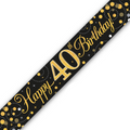 A black 40th birthday banner or sash printed with 'Happy 40th Birthday!' in gold script and numbers, decorated with gold and silver confetti dots, shown diagonally on a white background.