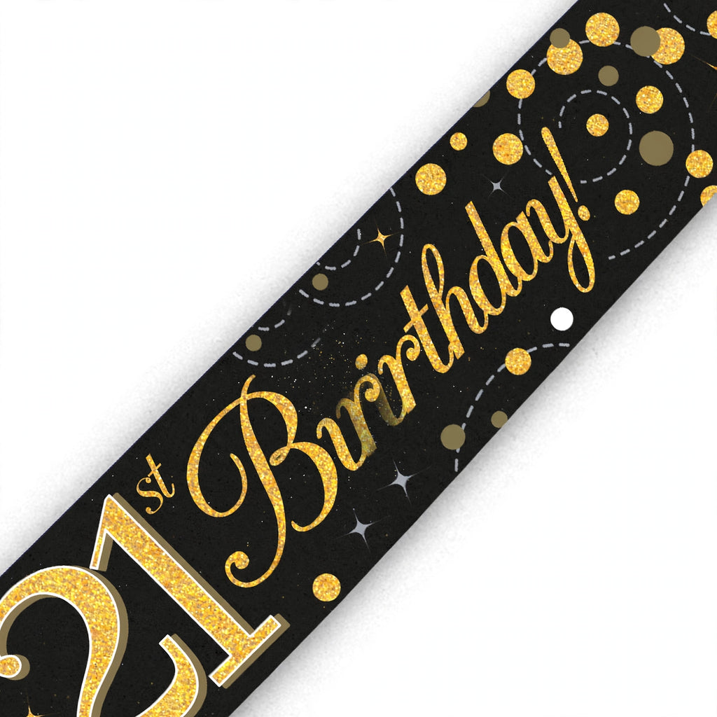 Close-up of black and gold 21st birthday banner with sparkling fizz design