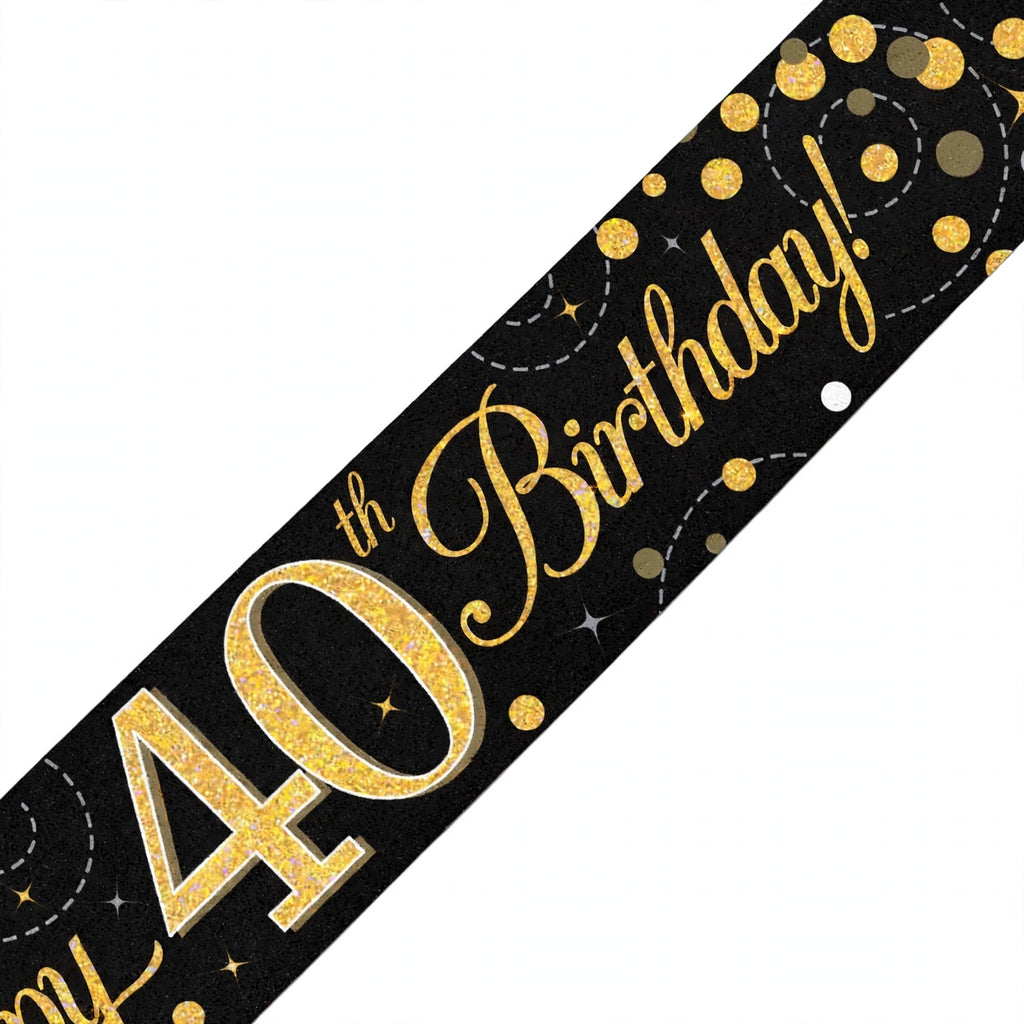 Close-up of black and gold 40th birthday banner with sparkling fizz design