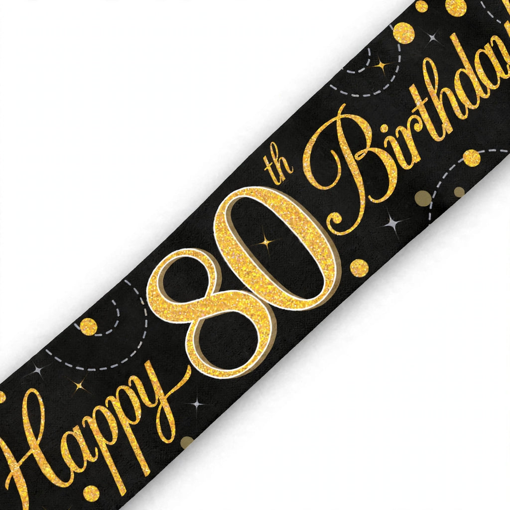 Close-up of black and gold 80th birthday banner with sparkling fizz details