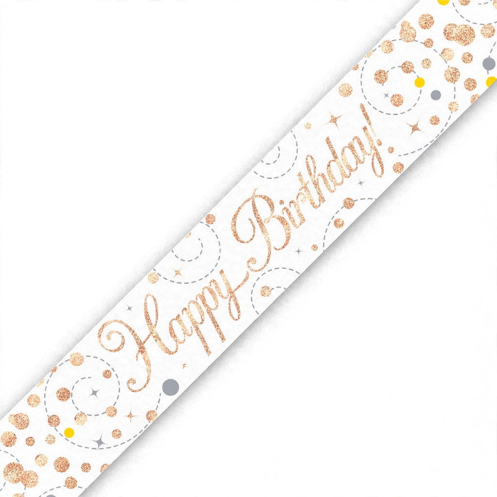 Close-up of rose gold and white Happy Birthday banner with sparkling fizz detailing