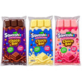 Three packaged Squoshies Choco Bar candies shown side by side on a white background: dark chocolate brown, creamy yellow, and pink. Each package has colorful branding and candy bar graphics.