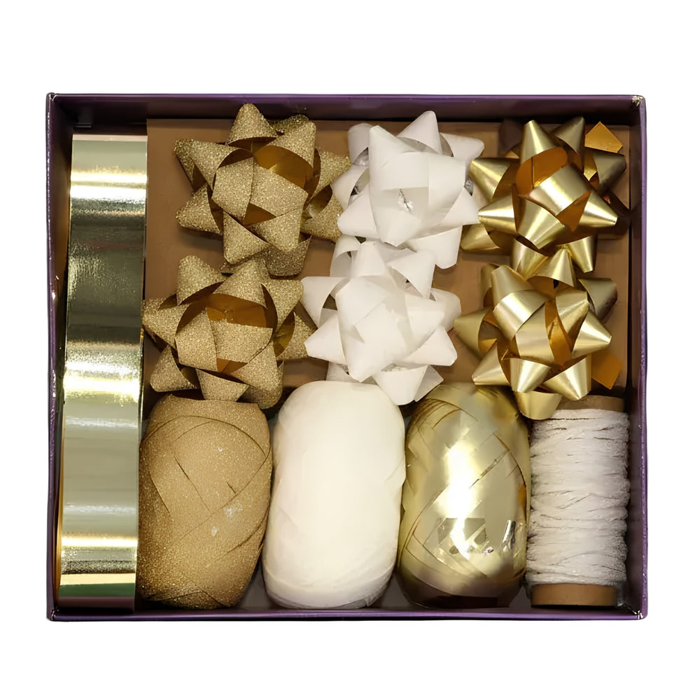 A gift decoration set in a rectangular box, featuring gold and white ribbons, gift bows, and thread spools on a white background.