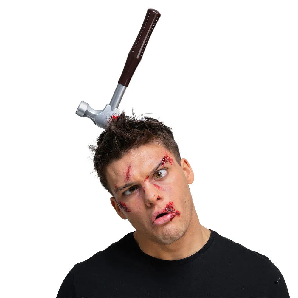 Man with zombie make-up wearing the hammer in head Halloween headband prop