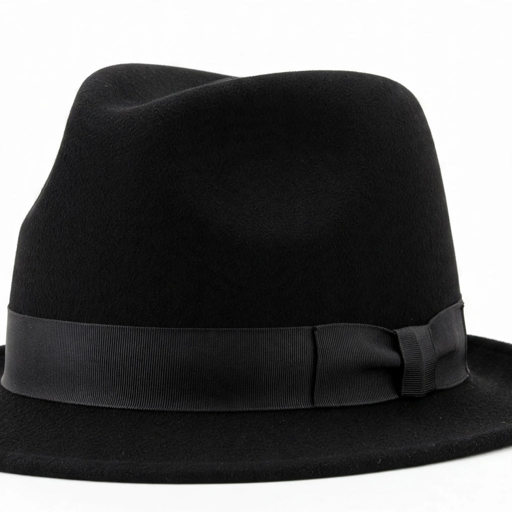 Close-up view of adults black trilby fedora style hat showing pinched crown and short brim