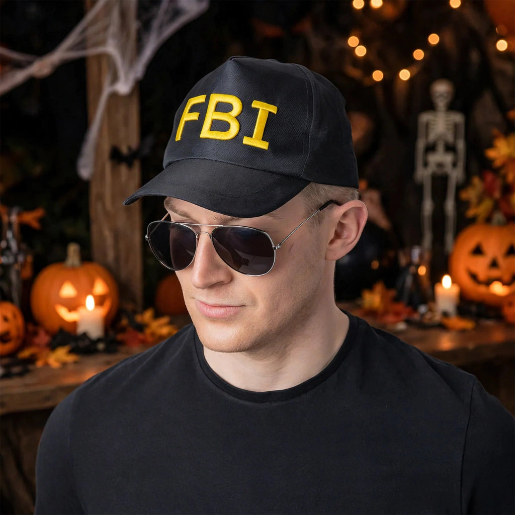 Person wearing black and yellow F.B.I baseball cap at a themed party