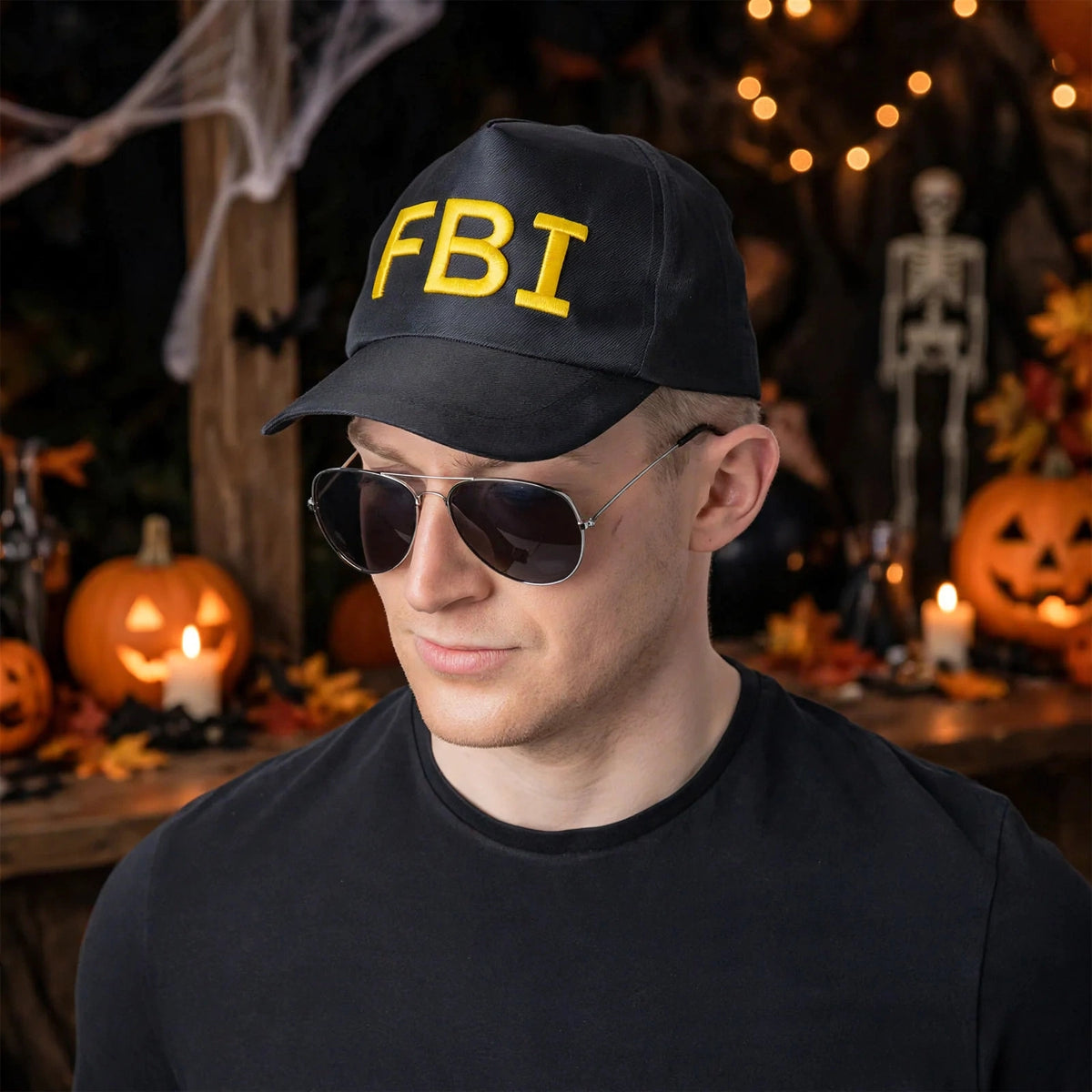 Person wearing black and yellow F.B.I baseball cap at a themed party