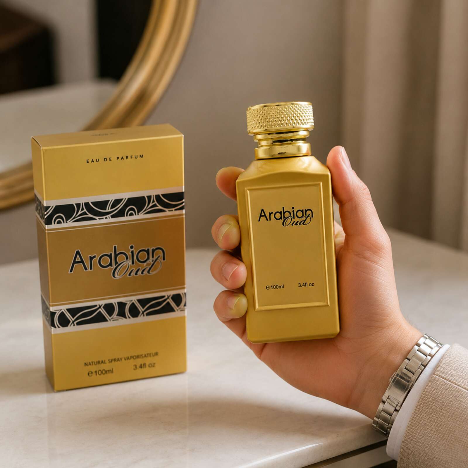 Adult holding Arabian Oud 100ml fragrance bottle beside its box