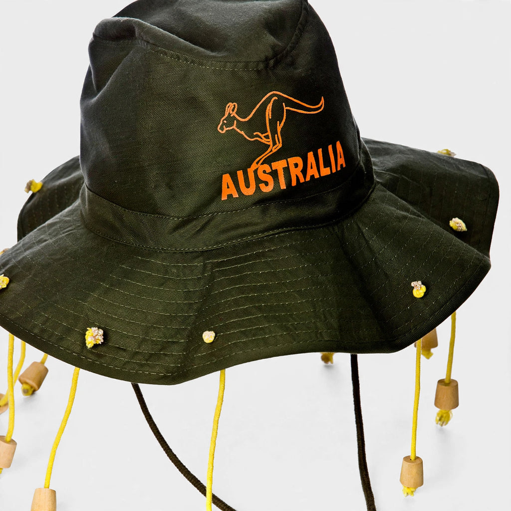 Close-up of green wide-brim hat with orange corks and embroidered kangaroo