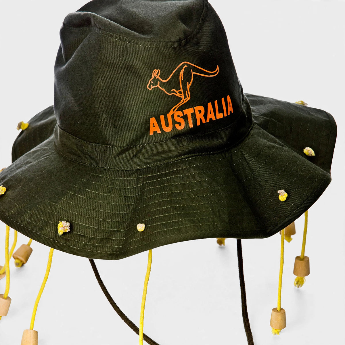 Close-up of green wide-brim hat with orange corks and embroidered kangaroo