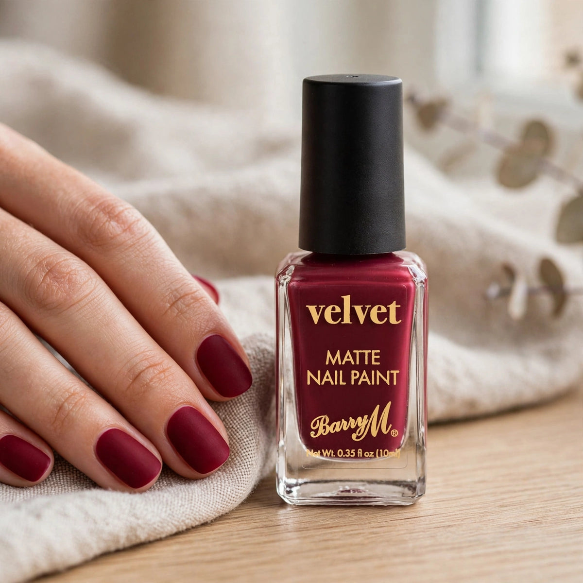 Nails painted with Barry M Red Velvet Nail Polish Crimson Couture 115 showing deep crimson matte finish