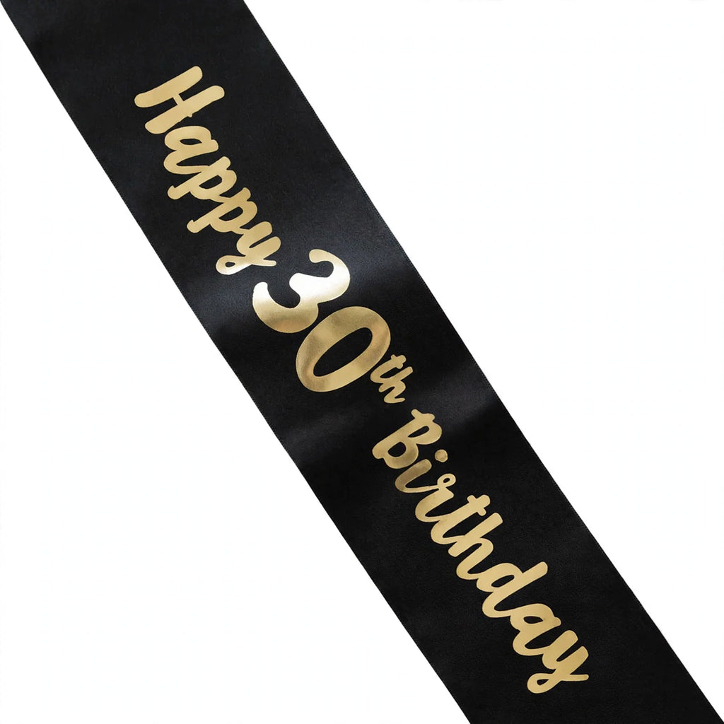 Close-up view of black and gold 30th birthday sash text and diagonal style