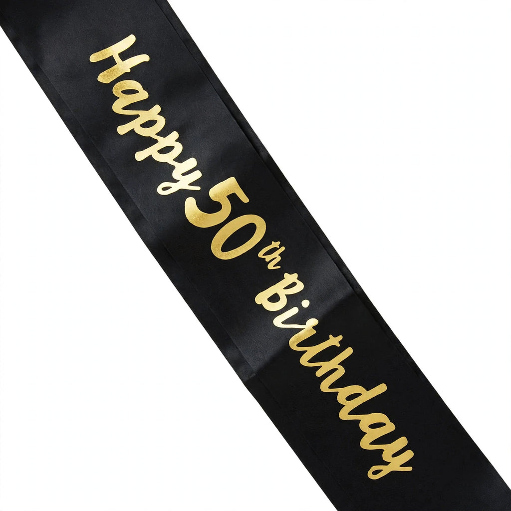 Close-up view of black and gold 50th birthday sash with gold text