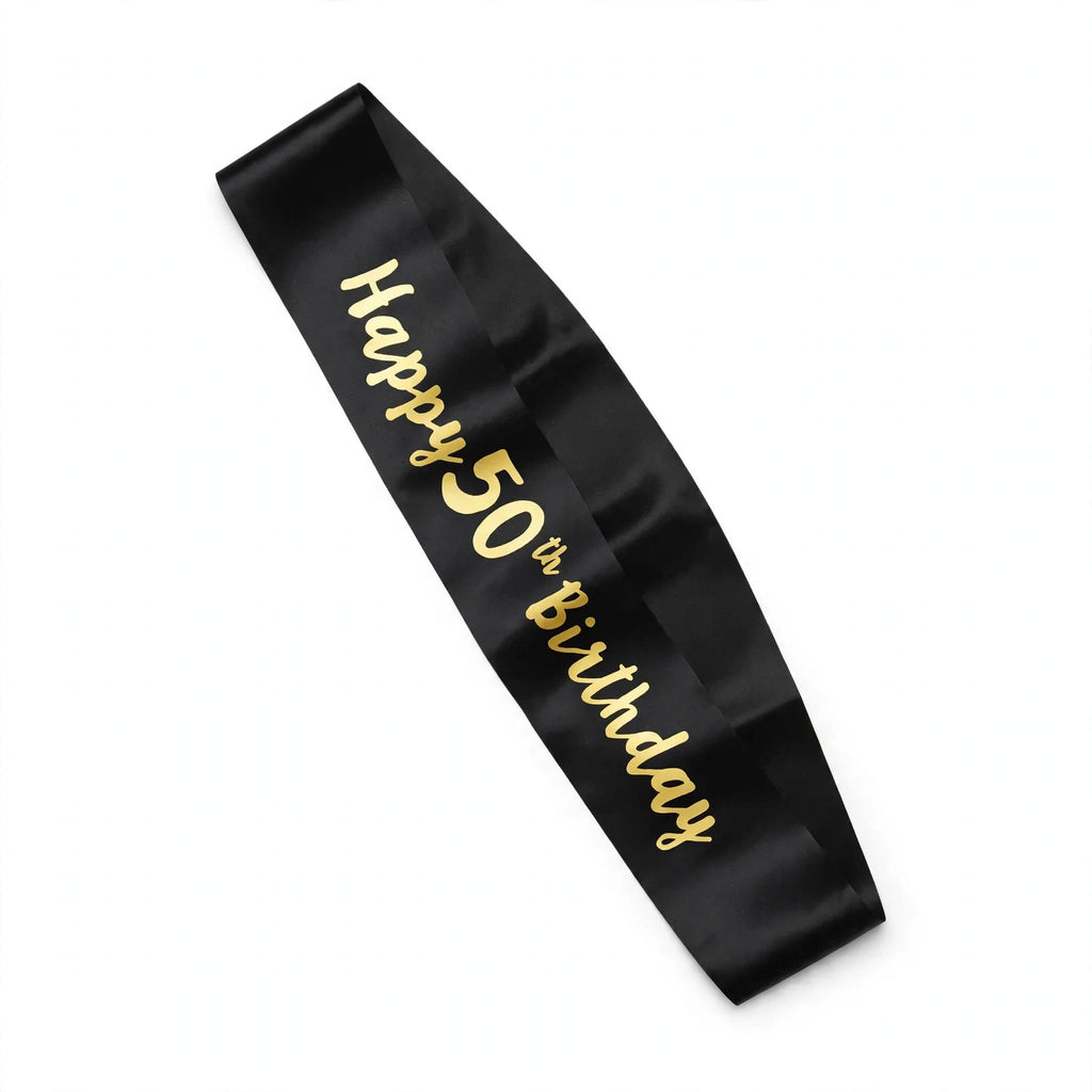 Black and gold 50th birthday sash with gold text worn diagonally over one shoulder