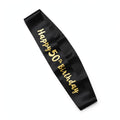 Black and gold 50th birthday sash with gold text worn diagonally over one shoulder