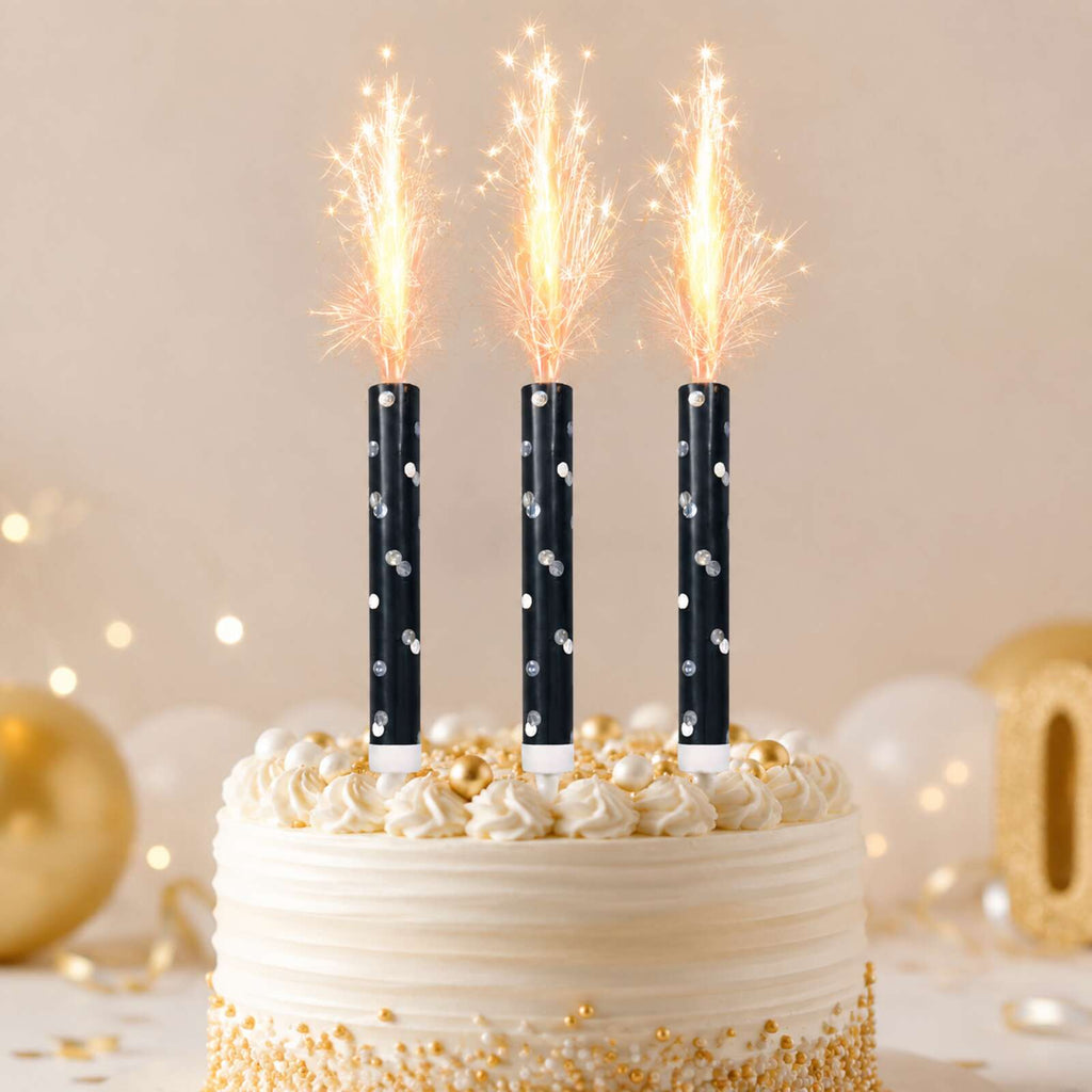 Three black glitz ice fountains safely lit on a celebration cake