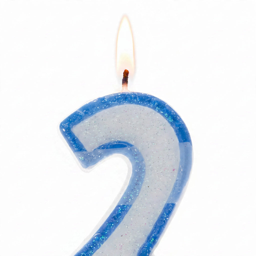Close-up of blue glitter number 2 birthday candle