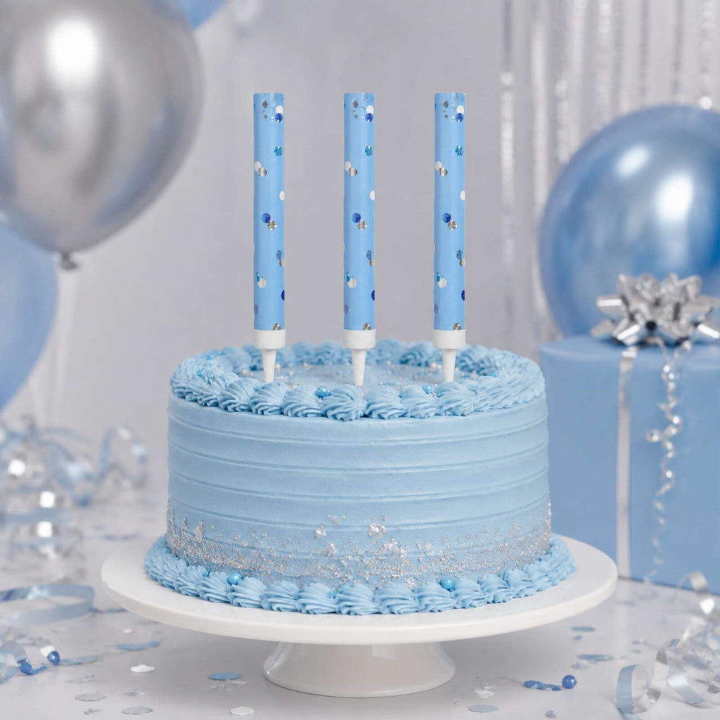Three unlit blue glitz cake fountains displayed on a blue cake