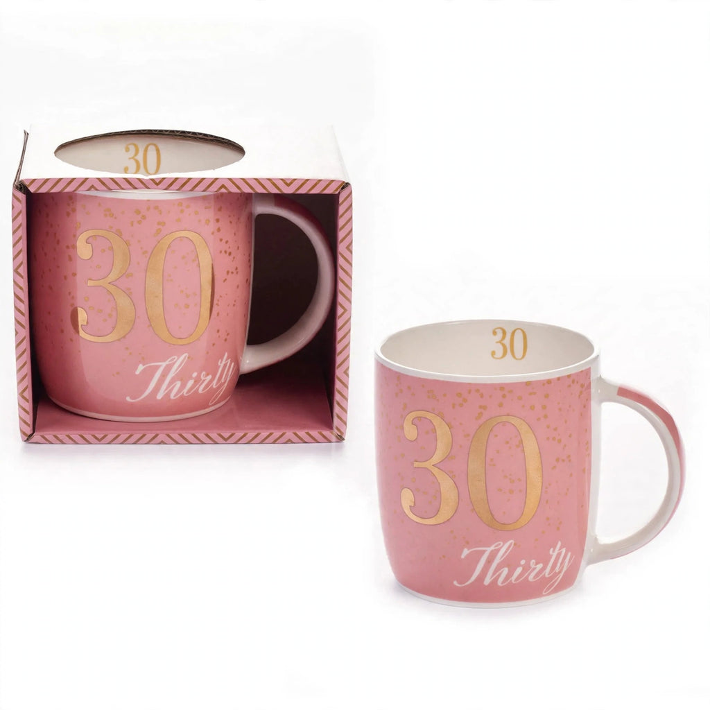 Close-up view of boxed birthday gift mug with pink and gold design