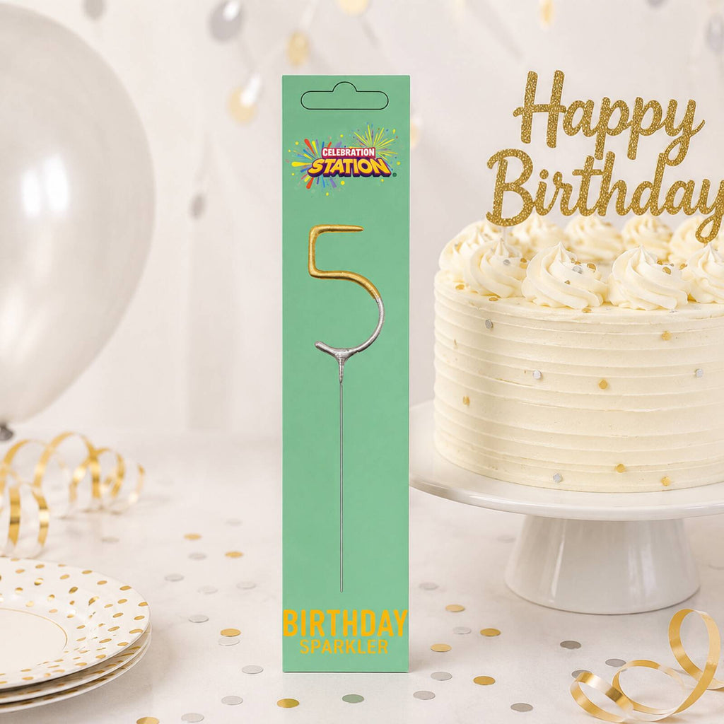 Packaged number 5 birthday sparkler displayed beside a decorated birthday cake