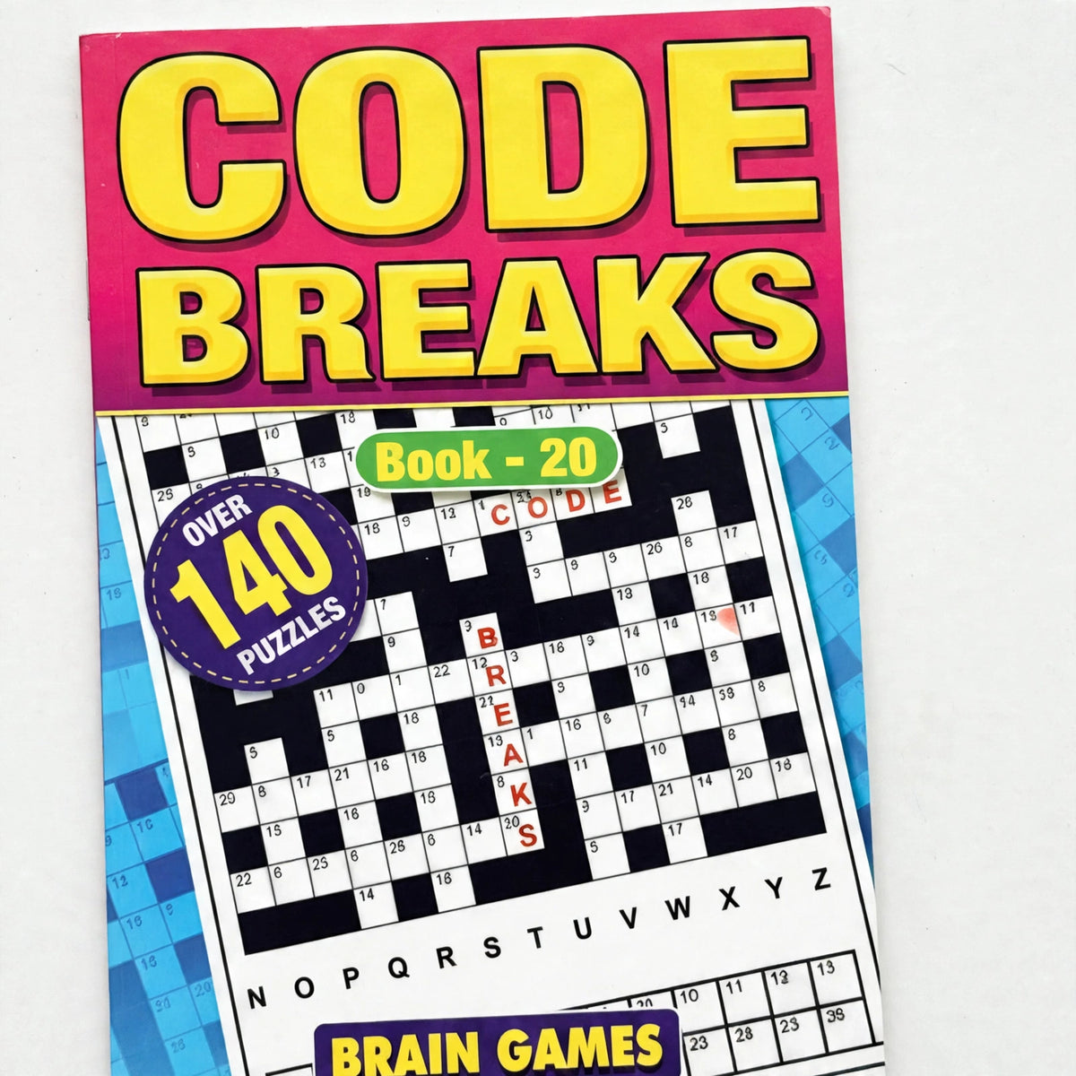 Close-up view of Code Breaks Puzzle Book A5 cover and branding