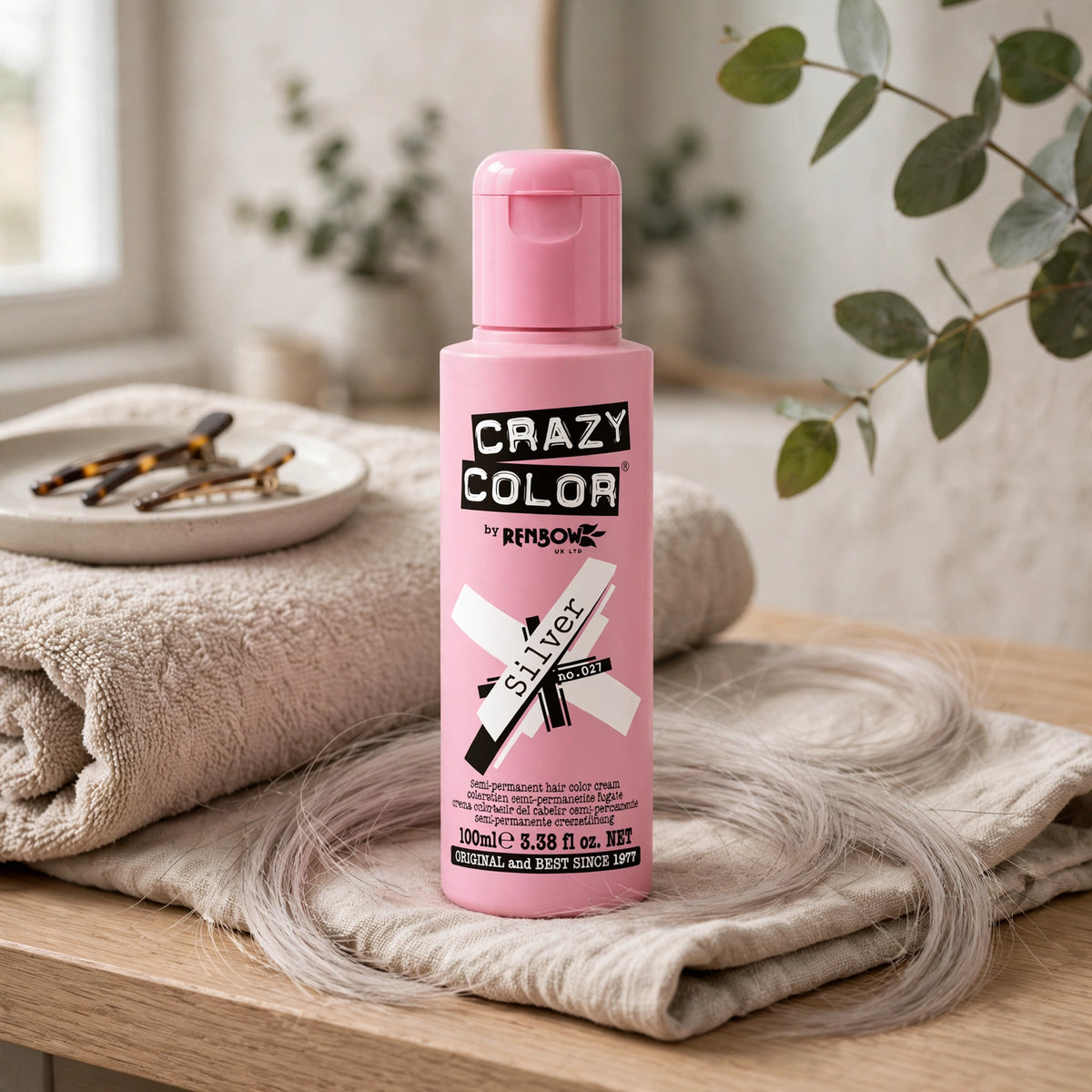 Model applying Crazy Color Silver Semi-Permanent Hair Dye to hair in a bathroom setting