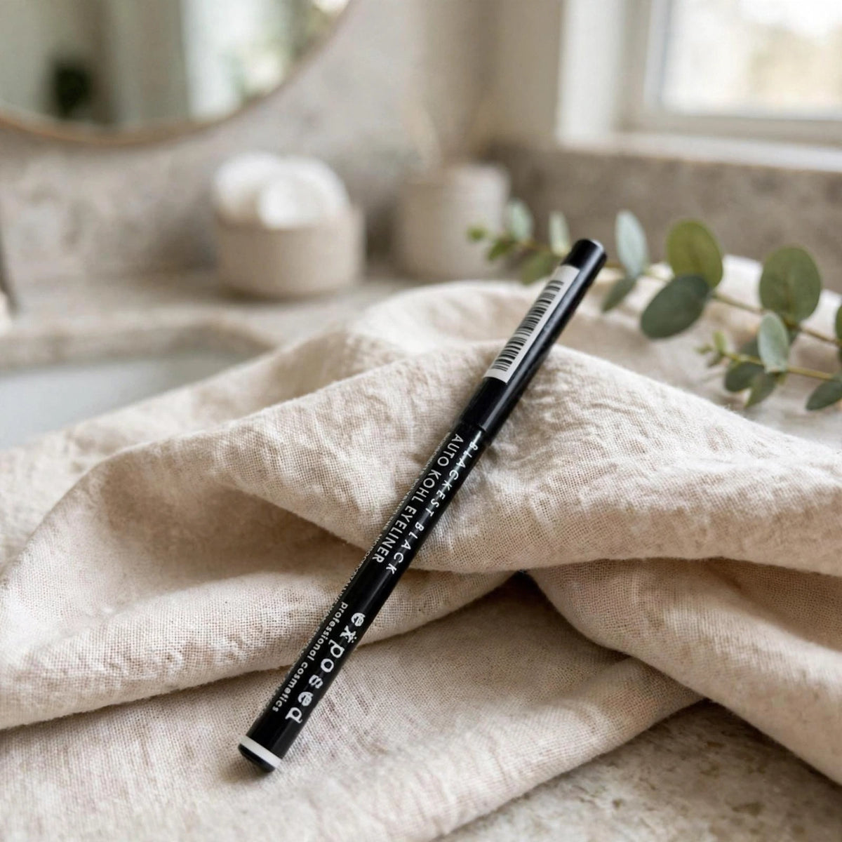 Eyeliner pencil displayed with makeup items for everyday use