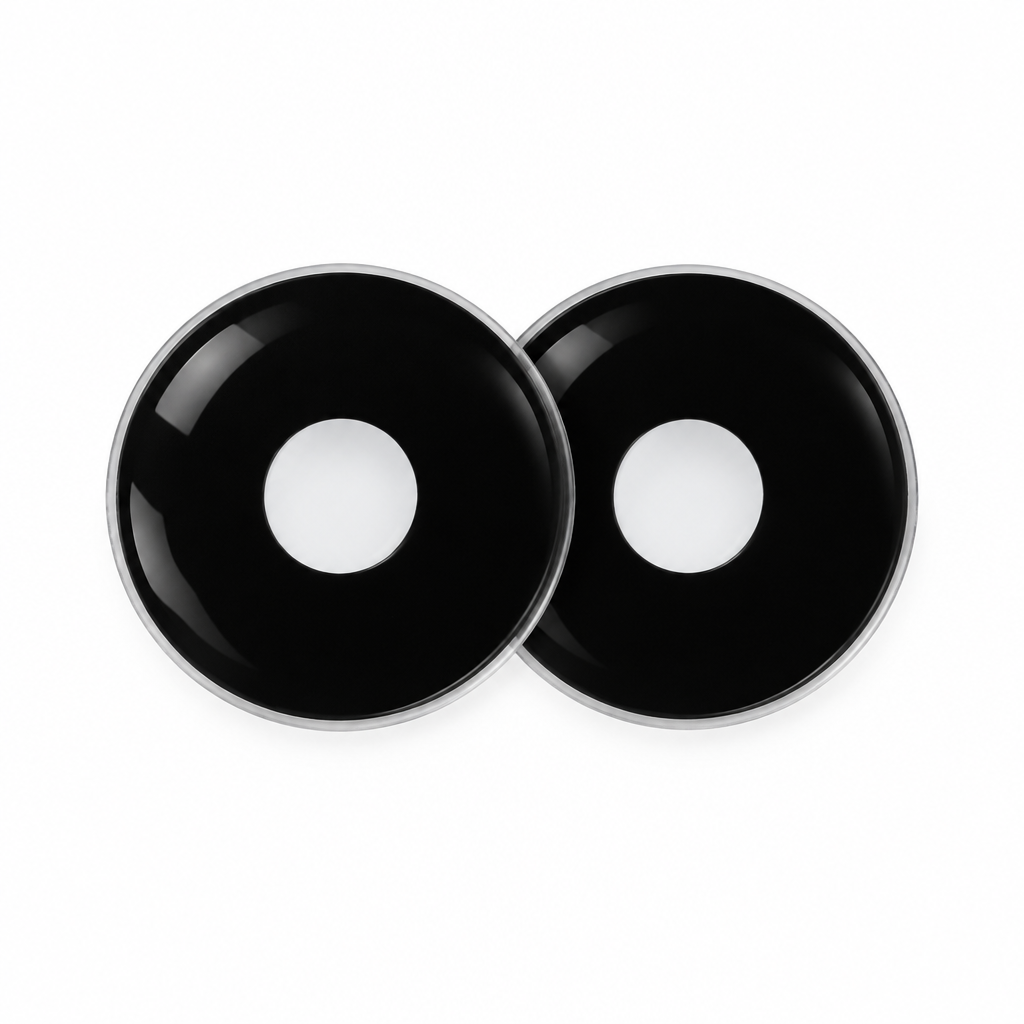 Two round black contact lens-shaped pieces with a glossy finish and a silver rim, displayed on a clean white background.