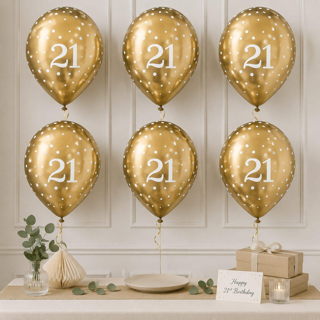 Six gold 21st birthday balloons arranged as a party backdrop