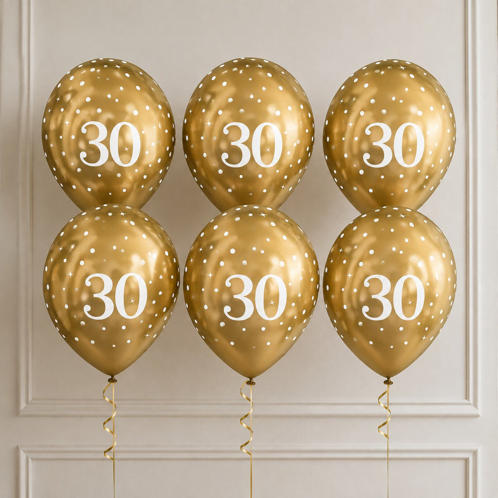 Six gold 30th birthday balloons arranged as a photo backdrop