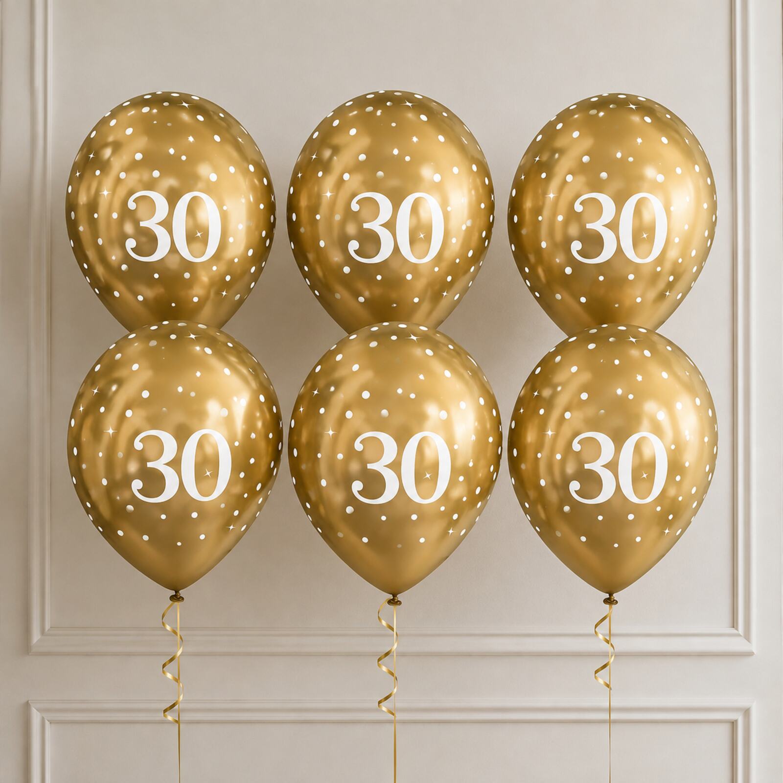 Six gold 30th birthday balloons arranged as a photo backdrop