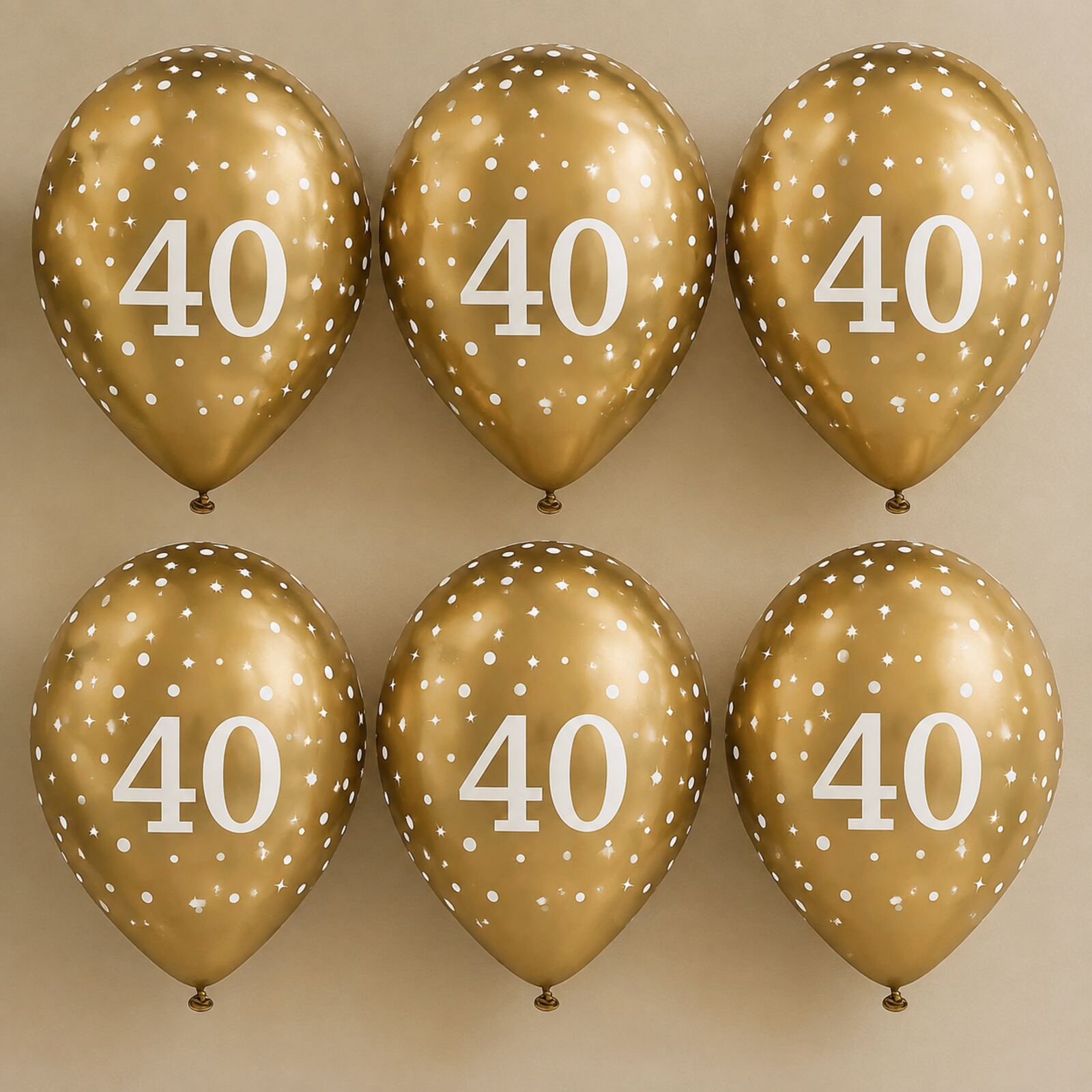 Six gold 40th birthday balloons arranged as a photo backdrop