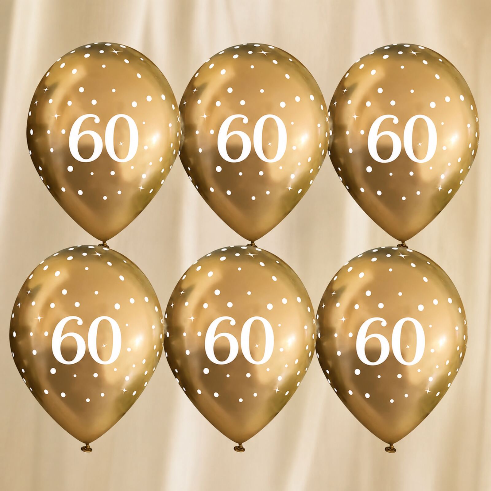 Six gold 60th birthday balloons arranged as a photo backdrop