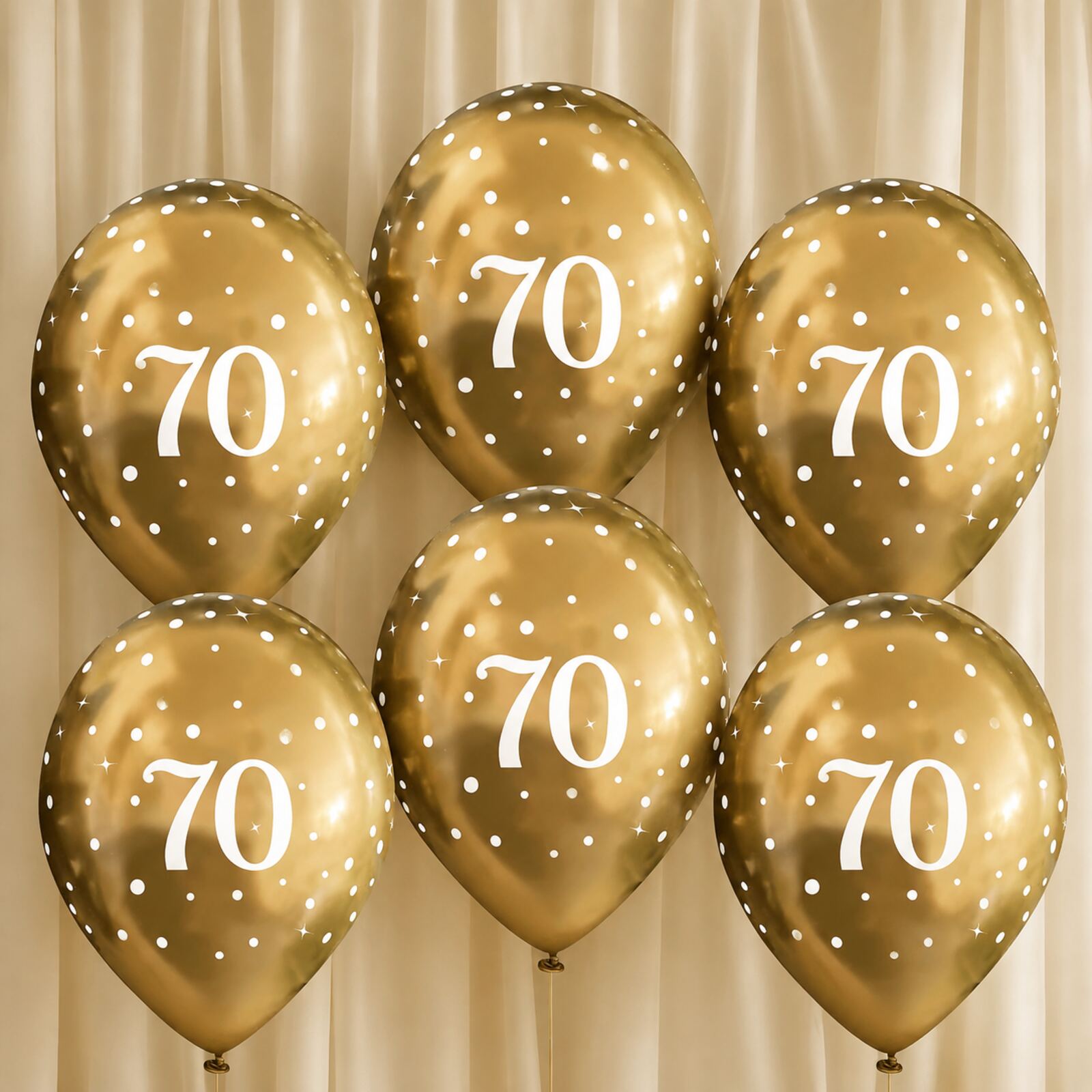 Six gold 70th birthday balloons arranged as a photo backdrop