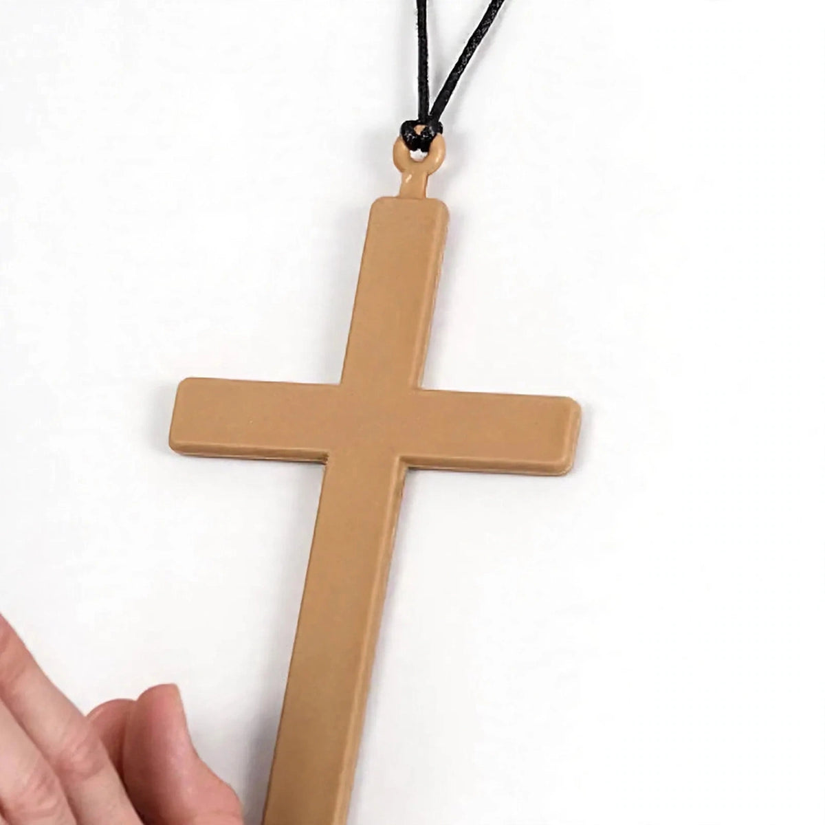 Close-up view of gold-tone PVC cross for religious fancy dress
