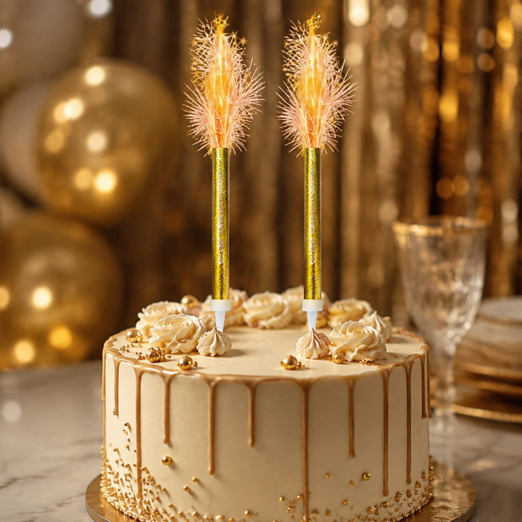 Two gold prismatic ice fountain decorations sparkling on a celebration cake