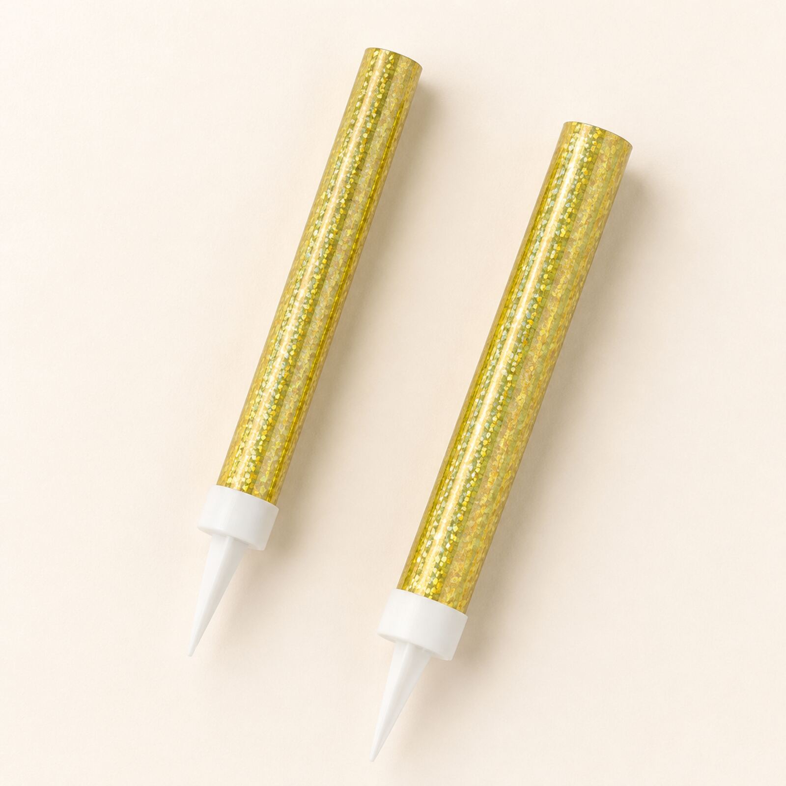 Two gold prismatic ice fountain cake decorations showing foil finish and white spikes