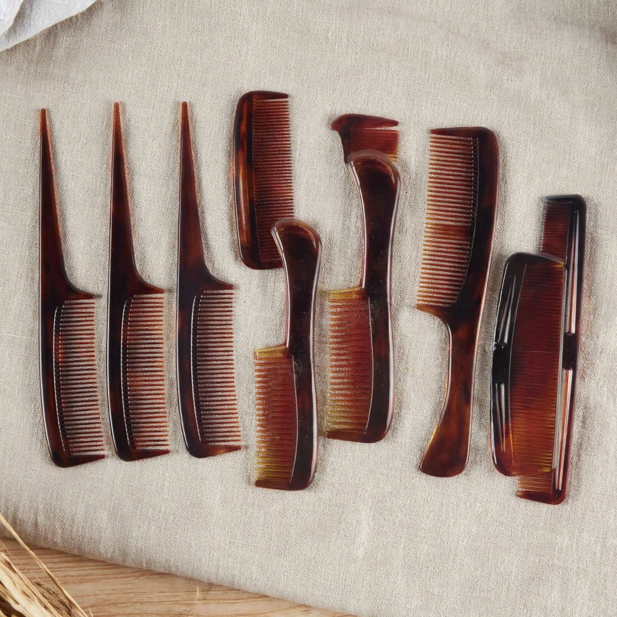 Brown tortoiseshell style hair comb being used for styling hair