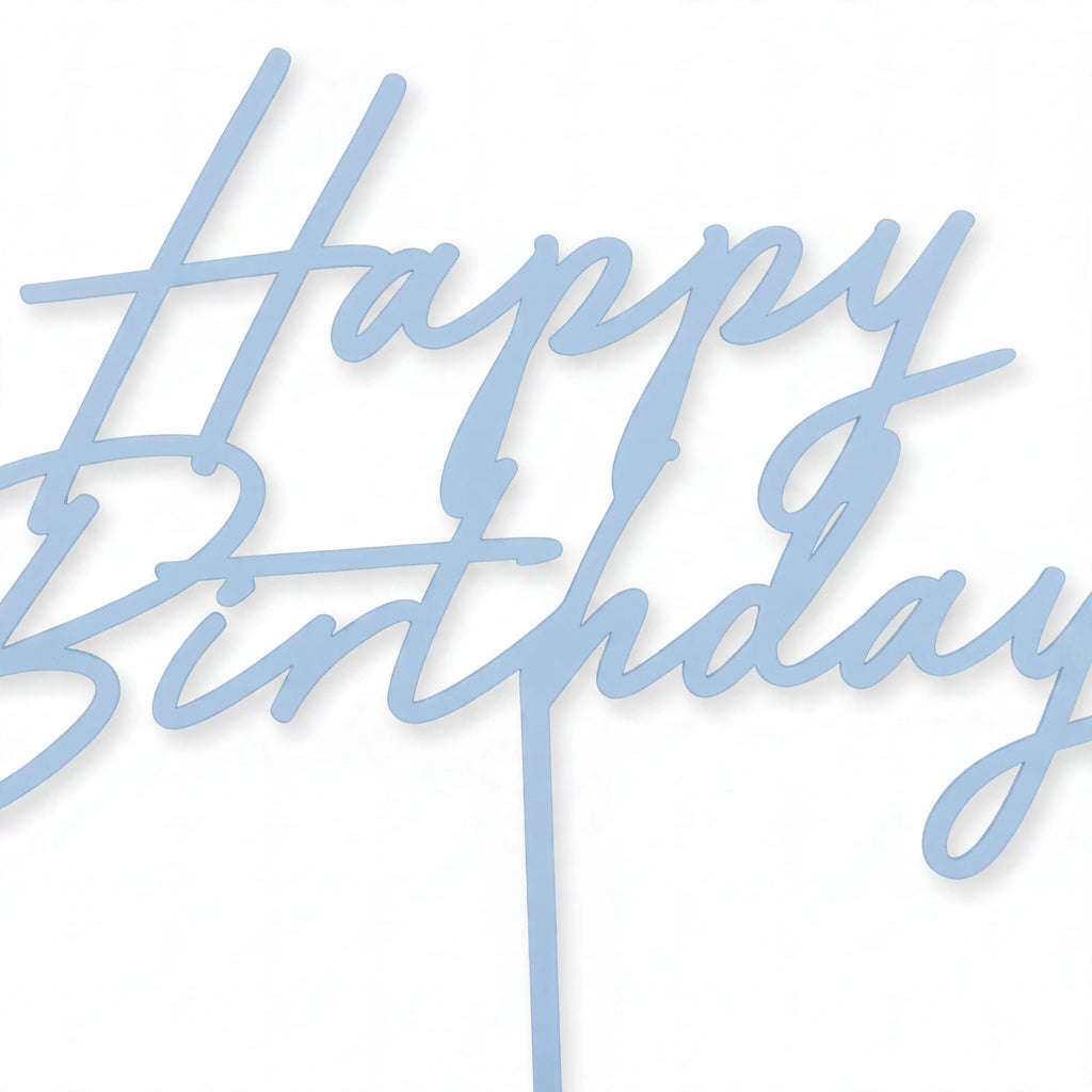 Close-up of misty blue acrylic Happy Birthday cake topper showing script-style lettering