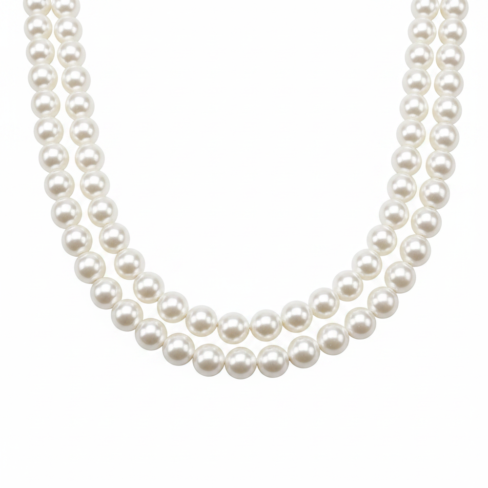 Pair of white pearl necklaces displayed on white background studio product shot