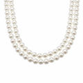 Pair of white pearl necklaces displayed on white background studio product shot