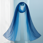 Navy blue to sky blue gradient chiffon scarf draped on white background showing sheer fabric and colour gradient