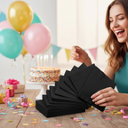 Black luncheon napkins at a birthday party celebration with balloons and confetti