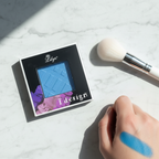 Lilyz Eyeshadow Mono Electric Blue on marble surface with makeup brush and colour swatch