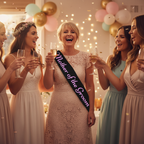 Mother of the Groom wearing black hen party sash with pink writing, raising champagne glass with bride and bridesmaids at hen party celebration